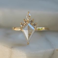 a diamond ring sitting on top of a white cloth