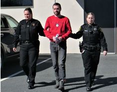 three police officers walking down the street with their hands in each other's pockets