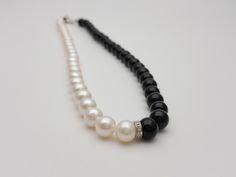 "This elegant and timeless pearl necklace is a must-have in a woman's wardrobe. It goes perfectly with almost anything It's a beautiful classic 18K white gold and real diamonds 8mm black and white pearl and black agate necklace The necklace length is 17.5\". It may be adjusted down to 17 inches. - created by exclusive Nimei brand designers Includes one 18K white gold and real high-quality diamond rondel The pearls are white, smooth and shiny with high luster 8x8.5 Chinese freshwater cultured pea Elegant Black Pearl Necklace For Weddings, Elegant Black Pearl Necklace For Evening, Elegant Black Pearl Necklace, Elegant Black Single Strand Pearl Necklace, Elegant Black Round Pearl Necklace, Black Agate Necklace, Black Agate, Pearl Strands, Agate Necklace