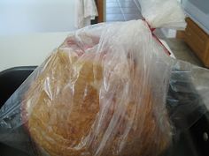 a plastic bag filled with food sitting on top of a stove