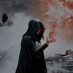 a woman with a hood on holding a fireball in front of her face and an eagle flying over her head