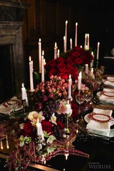 a table topped with lots of candles and flowers