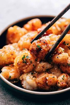 chopsticks sticking out of some food in a bowl