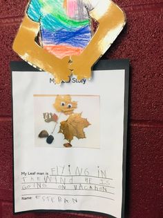 a bulletin board with an image of a child's hand holding a maple leaf