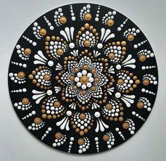 a black plate with white and brown designs on it