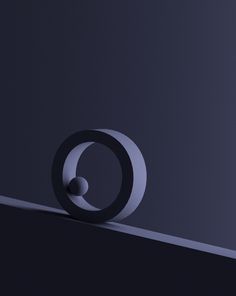 an abstract photo of the letter o on a black surface with light coming from behind it