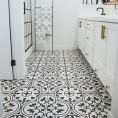 a bathroom with black and white tile flooring