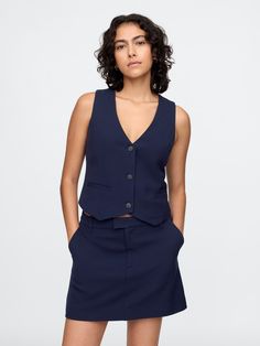 Smooth woven cropped vest.  V-neck.  Sleeveless.  Button front.  Welt pockets.  Fit: Close to the body.  Cropped, hits at the waist.  Models wearing Gap Cropped Vest, Welt Pockets, New Woman, Welt Pocket, The Body, Old Navy, Gap, Navy Blue, Models