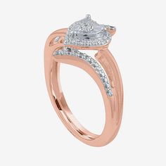 a rose gold engagement ring with two diamonds on the band and an oval shaped center stone