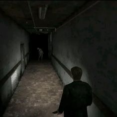 a person walking down a dark hallway with a dog on the other side and another person in the background