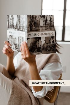 a woman sitting on a chair holding up a book with photos in it and the title paris changing