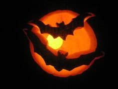 a carved pumpkin with a bat on it