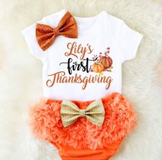 Personalize your baby girl's holiday style with this adorable first Thanksgiving set! She'll look oh so cute in this ruffled number! We'll customize the baby one-piece or t-shirt with any name! Just write it in the personalization box below. Our hand-sewn sequin bows give this super cute diaper cover a classy look! 100% cotton top short & long sleeve lengths baby bodysuits and t-shirts available orange ruffled diaper cover is a poly/cotton blend gold bow is attached to the front of the diaper co Babys First Thanksgiving, Girls Holiday Outfit, Thanksgiving Baby Outfits, Girls Thanksgiving Outfit, Halloween Clothes, Girls Thanksgiving, Hallowen Costume