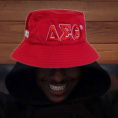 a person wearing a red hat with the word fraternity on it's brim