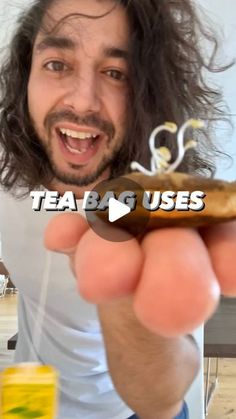 a man with long hair holding up a donut in front of his face and the words tea bag uses on it