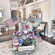 a table topped with lots of patriotic items on top of a kitchen counter next to a chair