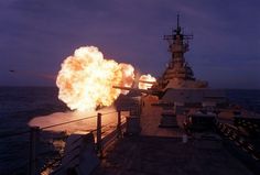 a large fireball is being fired on the deck of a ship