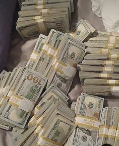 a pile of money sitting on top of a bed with the words, $ 10 million dollars