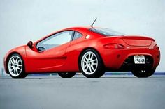 a red sports car is parked on the street