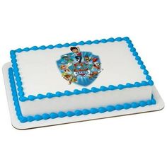 a white and blue cake with an image of superman on it