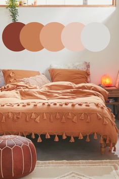 a bedroom with orange and brown colors on the walls, bedding and rugs