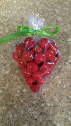 a bag filled with red berries sitting on top of a counter