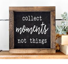 a blackboard with the words collect moments not things on it next to some books