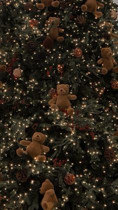 a large christmas tree with teddy bears on it