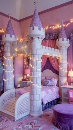 a princess castle bed with lights on the walls