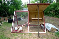 a chicken coop in the middle of a yard