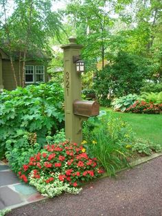 a mailbox in the middle of a flower garden