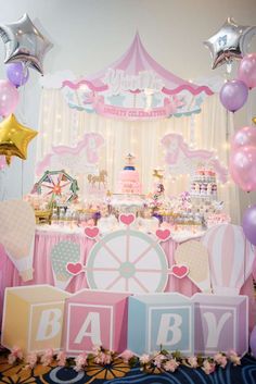 a carousel themed baby shower with balloons and decorations