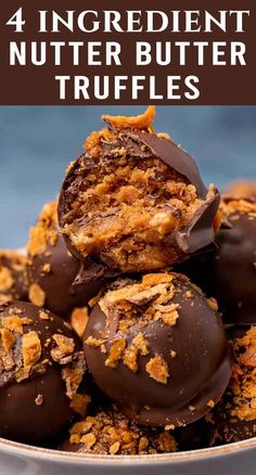 chocolate covered peanut butter truffles stacked on top of each other in a bowl