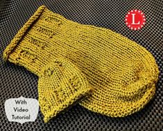 a yellow knitted mitt sitting on top of a table