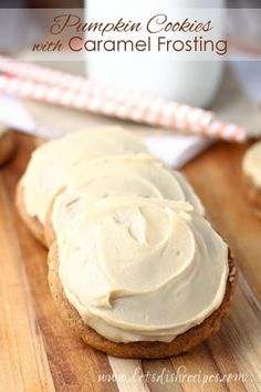 pumpkin cookies with caramel frosting on a cutting board