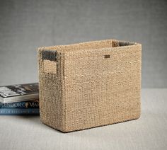 a basket sitting on top of a table next to two books