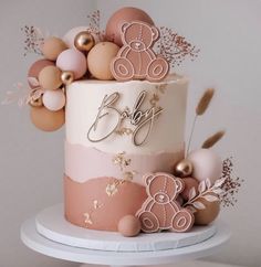 a three tiered cake decorated with pink and gold decorations