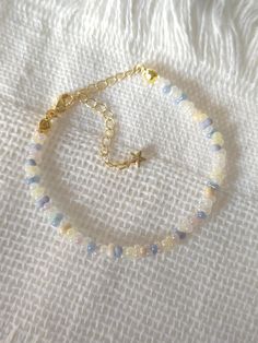 FOR OTHER DAINTY BEADED BRACELETS: https://www.etsy.com/ca/shop/ArtiChouXCanada?ref=seller-platform-mcnav§ion_id=46088511 Bracelet Length: 13-18cm (5.1-7 inches) with a 14k gold filled extender. This bracelet features an array of summer themed pastel colors: blue, white, cream, and light purple Japanese seed beads.  Thread may be visible since it is a handmade product   SIZING  Wrap a soft measuring tape snugly around the widest part of your wrist. Add 1.27cm (0.5in) to that measurement to determine the right bracelet size.  MATERIALS  - Japanese MGB glass seed beads(2x4mm) - 14K gold filled extender  CARE INSTRUCTIONS   To maintain its radiance, gently clean the bracelet with a soft cloth and store it in a jewelry box or pouch when not in use.   SHIPPING INFORMATION  Canada: Standard Ship Bead Bracelet Cute, Pretty Seed Bead Bracelets, Pastel Beaded Bracelets, Seed Bead Patterns Bracelet, Seed Bead Bracelet Designs, Glass Beaded Bracelets Ideas, Glass Seed Bead Bracelet Ideas, Cute Seed Bead Bracelets, Beaded Bracelet Designs