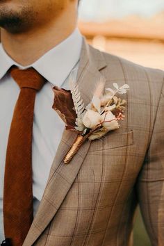 a man in a suit with a boutonniere on his lapel