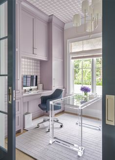 a home office with purple walls and furniture