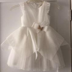 Perfect For Baptism Or Flower Girls. White Tulle And Flutter Detail On Sleeves. Butterfly Brooch On Waist. Spring Baptism Tutu Dress With Bow, Summer Baptism Tutu Dress With Bow, Fitted Tutu Dress With Bow For Baptism, Summer Tutu Dress With Bow For Baptism, Elegant Ruffled Tutu Dress For First Communion, White Bow Tutu Dress For Summer, Spring First Communion Dress With Bow, Sleeveless Ruffled Princess Dress For Baptism, Ruffled Tutu Dress For First Communion