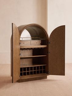 an open wooden cabinet with wine bottles in the bottom section and shelves on each side