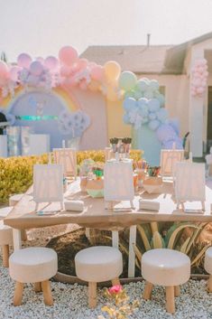 a table set up with balloons and decorations for a baby's first birthday party