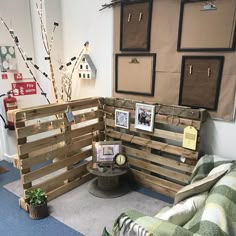 a living room with wooden pallets and pictures on the wall