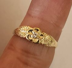 This is a beautiful 14KT yellow gold 5 pedal rose ring accented with a 3 pt si 1 gh color .03 pt diamond. Can be set with a different stone by request.This is one of my first carvings paying close attention to detail. Will always remain a classic. Comes in sizes 5 to 8. Allow 10 days handling time. Bell Gardens, Grunge Jewelry, Pretty Jewelry Necklaces, Handmade Gold Jewellery, Gold Jewelry Sets, Silver Jewelry Necklace, Gold Jewelry Simple, Gold Jewelry Necklace, Dope Jewelry