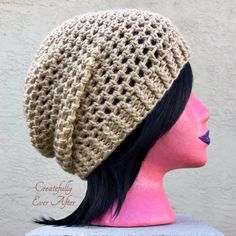 a mannequin head wearing a crocheted beanie on top of a dummy