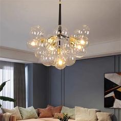 a living room filled with furniture and a chandelier hanging over the top of it