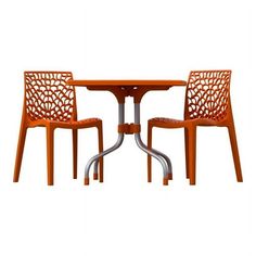 an orange table and two chairs sitting next to each other