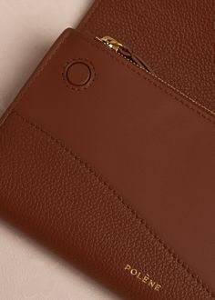 The "Sierra Wallet" incorporates two design features that are central to Polène's aesthetic: rounded shapes and leatherwork in contrasting colors and trim. Elegant Brown Coin Purse For Everyday, Classic Brown Business Coin Purse, Brown Bifold Coin Purse For Business, Modern Brown Clutch For Daily Use, Modern Cognac Wallets With Card Slots, Brown Travel Clutch With Interior Card Slots, Elegant Brown Coin Purse With Interior Card Slots, Formal Brown Coin Purse With Interior Card Slots, Formal Brown Coin Purse With Card Slots