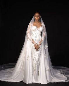 a woman in a white wedding gown and veil